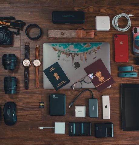 pexels photo 3031670 3031670 Flat lay of travel essentials including gadgets, passports, and camera on wooden surface.